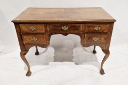 Early 20th century walnut veneer desk having a central long drawer flanked on either side by two