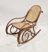 A 20th century Thonet bentwood rocking chair, having a woven rattan weave seat and back, stamped