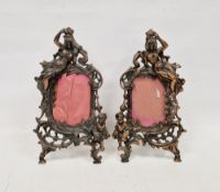 Pair of Late Victorian coppered spelter picture frames, each cast with a scantily draped figure of