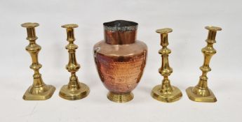 LOT WITHDRAWN Two pairs of brass baluster candlesticks, late 19th century and a planished copper