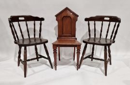 A Victorian mahogany gothic style hall chair raised on tapering turned front legs, measuring