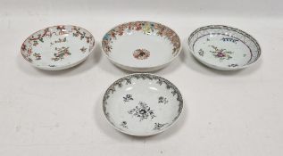 Two Chinese Export saucers comprising an example painted en grisaille with flower-sprays enriched in