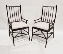 A pair of contemporary stained wooden oriental bamboo style armchairs, each with a detached seat