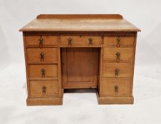 A late 19th/early 20th century pine kneehole desk/dressing table having a central long drawer