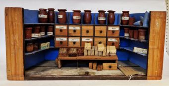 Victorian grocers shop interior with shelves, drawers, toy jars for coffee, currants, French
