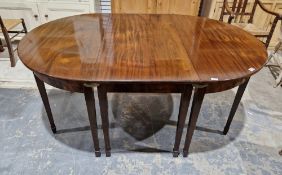 A reproduction Georgian style mahogany dining table in three sections, raised on square tapered