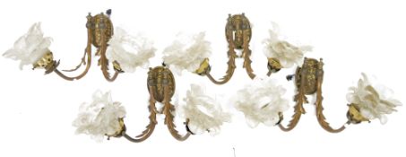 Group of gilt-metal and opaque glass wall lights, each with frosted glass petal-shaped sconces