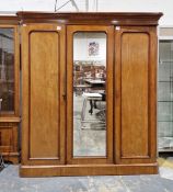 Victorian mahogany wardrobe with moulded cornice above central mirrored door flanked by two panelled