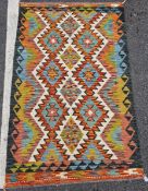 Chobi kilim, woven with geometric lozenges in blue, red, ochre on a cream ground within geometric
