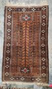 Baluchi brown ground rug, the central panel with tree of life style decoration containing stylised