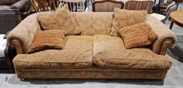 A Tetrad large three seat sofa upholstered in a coffee coloured fabric with floral decoration,