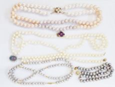 Double string of cultured pearls with pearl and pink stone clasp, a long string of cultured pearls
