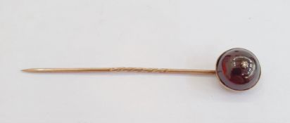 Gold-coloured, cabochon garnet and diamond stickpin set single tiny diamond