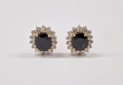Pair 18ct gold sapphire and diamond earrings, having large central oval sapphire surrounded by