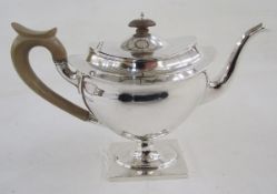 Early 20th century footed oval teapot and hinged cover, with turned wood handle and knop finial, the
