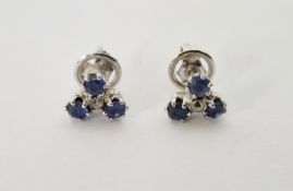 Pair of sapphire and diamond trefoil pattern earrings, three sapphires and single diamond to the
