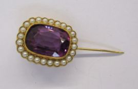 Antique gold-coloured metal, amethyst-coloured stone and seedpearl brooch having rounded rectangular