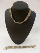 Silver triple-strand choker and matching bracelet with alternating beads and mesh.