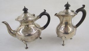 George V bachelor's silver teapot and matching hot water jug, having serpentine everted rim,