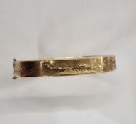 9ct gold bangle, slightly concave sides and fern engraved on a matted ground, 12.7g approx.