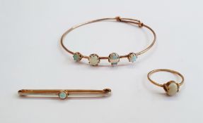 Gold-coloured and four-stone opal bangle set graduated oval opals, an opal bar brooch and an opal
