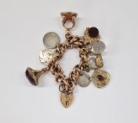 9ct rose gold curb-link charm bracelet with engraved padlock clasp and an assortment of antique gold