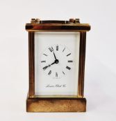 20th century brass carriage clock by the London Clock Company, with swing handle and bevelled