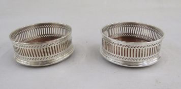 Pair of Elizabeth II silver and mahogany mounted wine bottle coasters, hallmarked London, 1982,