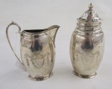 George V silver sugar caster and matching cream jug, each flattened oval, engraved with shield,