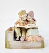 Early 20th century Vienna (Amphora) ceramic figure group of two Dutch children embracing, reading
