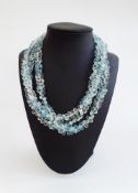18k white gold and aquamarine bead necklace, three-strand and with multiple faceted beads having