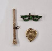 Gold-coloured heart-shaped locket, a silver and green enamel ribbon badge, and a gilt metal