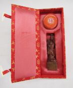 Chinese boxed seal set, a boxed Japanese ink stick/block and a carved green stone figure of a Buddha