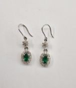 Pair 18ct white gold, diamond and green stone pendant drop earrings with flowerhead above the oval