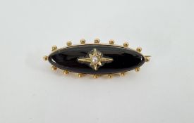 Victorian onyx and seed pearl mourning brooch, elliptical shape with glass locket to reverse.