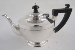 George V silver part tea-service, comprising: a teapot with hinged cover, turned wood handle and