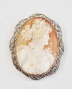 White metal cameo brooch, the oval carved cameo depicting girl with flowers in her hair, and wearing