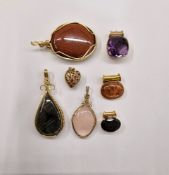 9ct gold and garnet pendant, oval, a gold-coloured metal and purple stone pendant, a gold-coloured