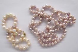 Long string of pink cultured pearls, a shorter string of pink grained cream pearls, two strings of