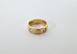 9ct gold and diamond dress ring, the band inset with three diamonds size M1/2