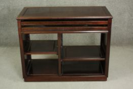 A late 20th century Chinese hardwood cabinet, with two retractable shelves above further shelves.