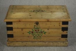An iron bound pine blanket box of plank construction, painted with a basket of flowers to the lid