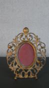A Victorian cast gilt metal photograph frame, with an oval aperture, the frame formed of scrolling