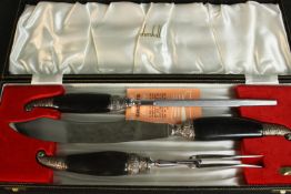A leather cased Dunhill buffalo horn and silver plate carving set. H.5 L.45 D.16cm.