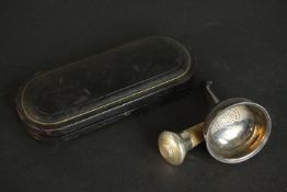 A pair of leather cased silver engraved grape scissors with scrolling pattern, along with a silver