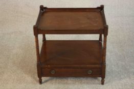 A George III style mahogany lamp table, of rectangular form with a gallery top on turned supports