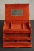 A burnt orange suede effect travelling jewellery case, with two sliding drawers and a sectioned