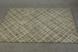 A contemporary John Lewis Croft Collection handmade Matlock rug in hues of grey, with labels to