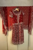 A very heavy red embroidered and beaded Indian bridal outfit, including sari and dress. (sized for a