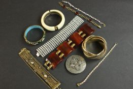A collection of costume jewellery, including a diamante articulated bracelet, a pearl and amethyst